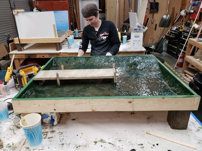 This is a 1/12 scale miniature lake we created with wooden fishing dock for the Del Taco "Hardest Working Hands in Fast Food" commercials.	