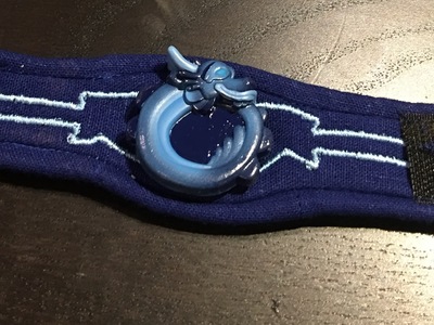 This is a modeled and 3d printed medallion on a custom sewn bracelet for the show Kody Kapow.	