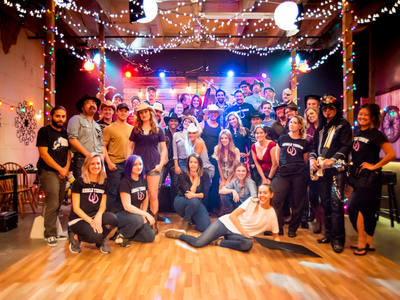 This is the cast and crew of Dianña's music video "Andale Yeehaw" that was shot on our country line-dancing bar pop up set.