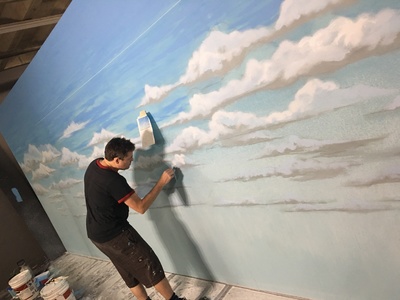 This is one of our many painted sky backdrops available for rent in the process of being painted by one of our talented artists.	